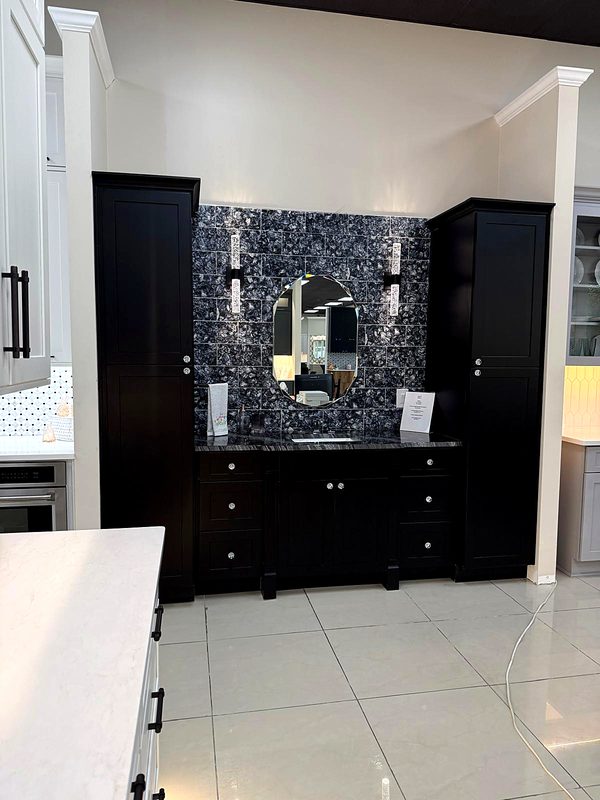 Black shaker vanity flanked by twin tall linen towers, crystal knobs, dark marbled — bathroom vanity by MNK Cabinet in Norcross, GA
