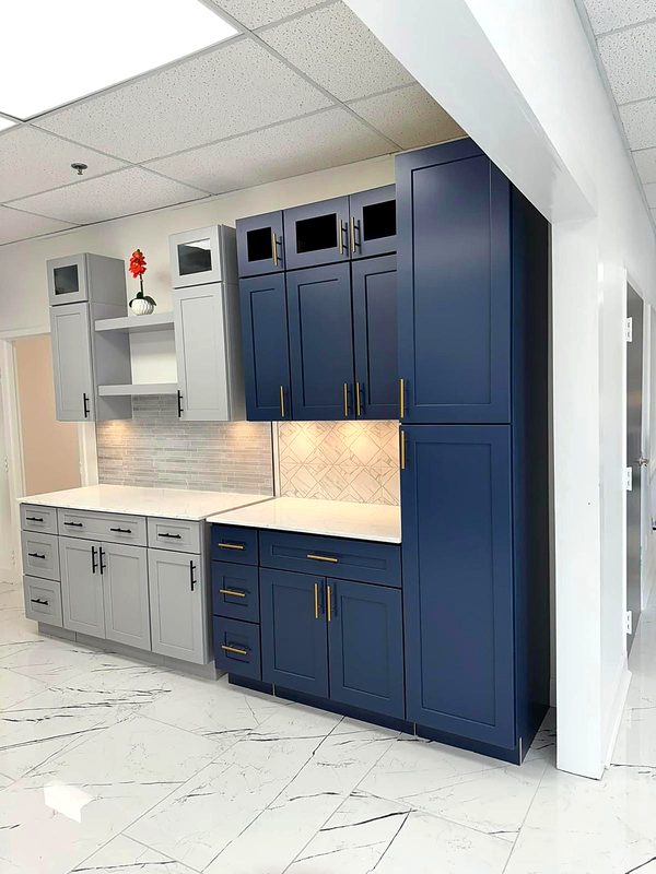 Showroom displays: navy blue shaker wall, base, and tall pantry cabinets with — on display at MNK Cabinet's Norcross, GA showroom